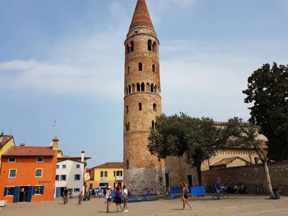 Caorle's cylindrical Romanesque bell tower and colourful houses