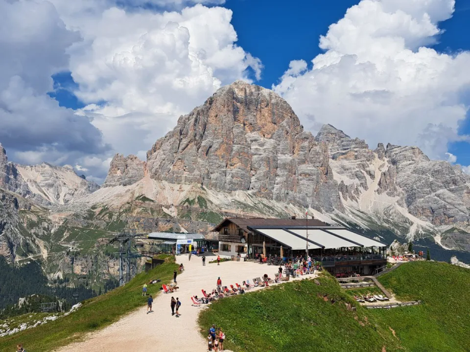 Mountain hut terrace at the Cinque Torri with the Tofana di Rozes behind